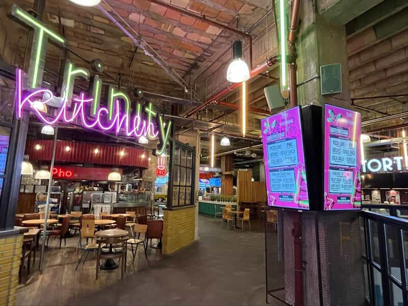 An image of the neon Trinity Kitchen signage.